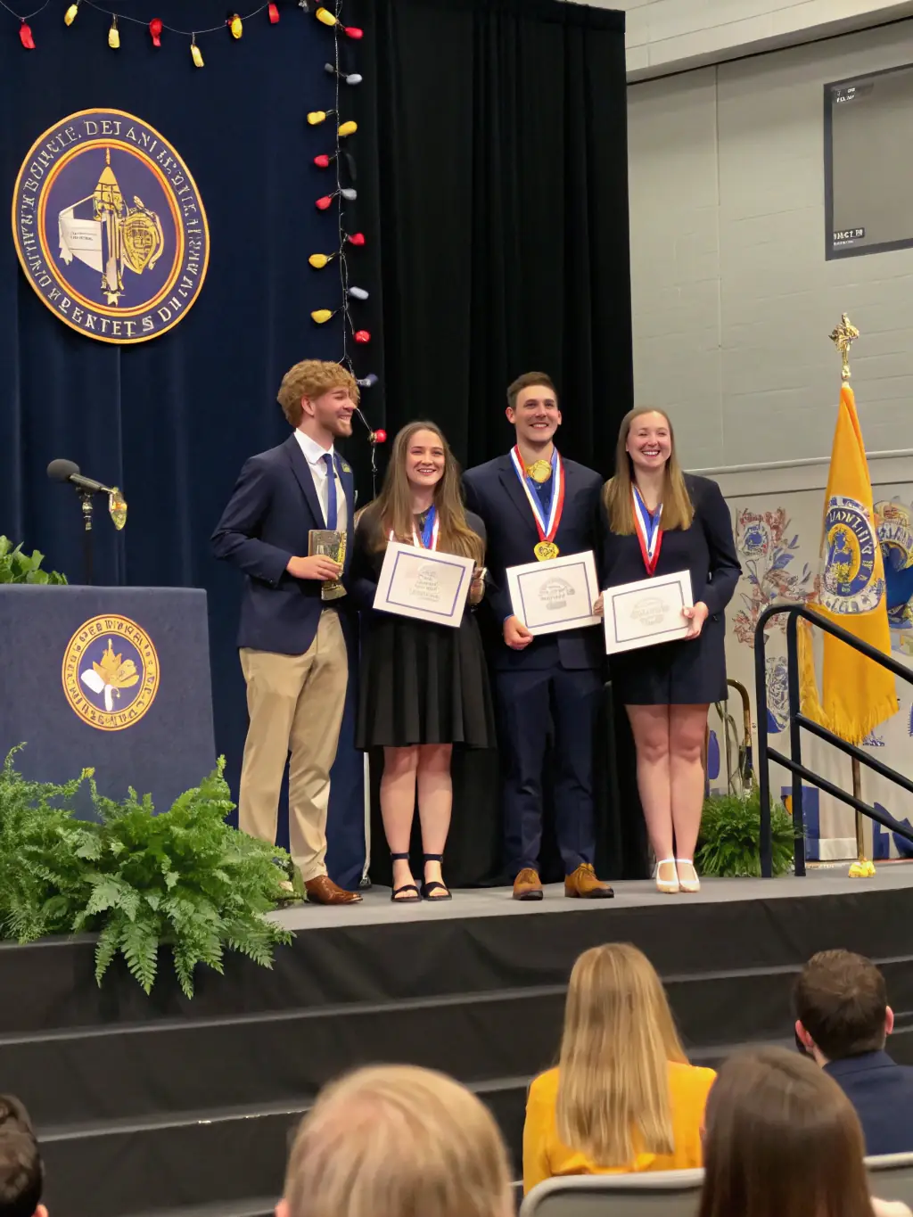 A picture of students presenting their cooperative's achievements to the school community, highlighting their accomplishments and impact. The image should convey a sense of pride and accomplishment.
